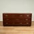 Chic mid century chest crafted in mahogany with seven asymmetrical drawers for plenty of storage, brass campaign style...