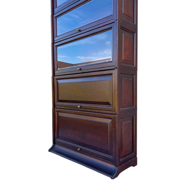 Globe-Wernicke style bookcase, classic English style, crafted from dark red mahogany and featuring bevelled glass at the...