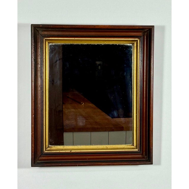 Antique American Victorian Walnut Mirror with Gilt Trim This stunning 19th-century American Victorian mirror exudes...