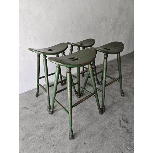 Great set of 4 vintage oak craftsman style barstools with original dark green finish with distressed details that give...