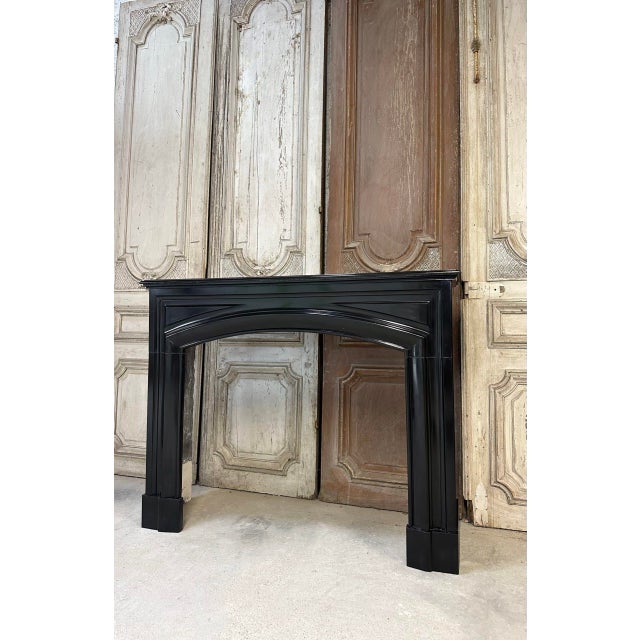 Louis xiv style fireplace in black belgian or mazy marble, circa 1900. The lintel features two panels at each end. The...