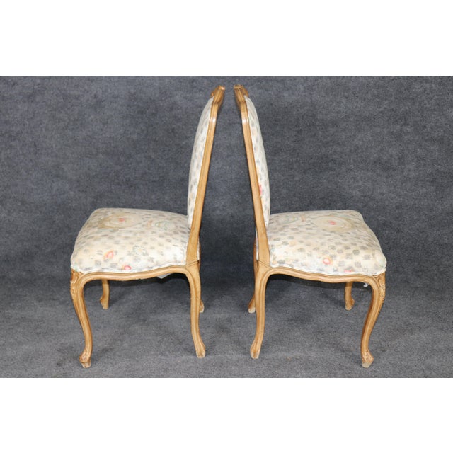 Enhance your dining room with the timeless elegance of this exquisite set of six French Louis XV style side chairs,...