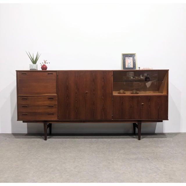 Long mid-century sideboard, o.m.f. bar area, display cabinet, three drawers, two storage compartments. very good...