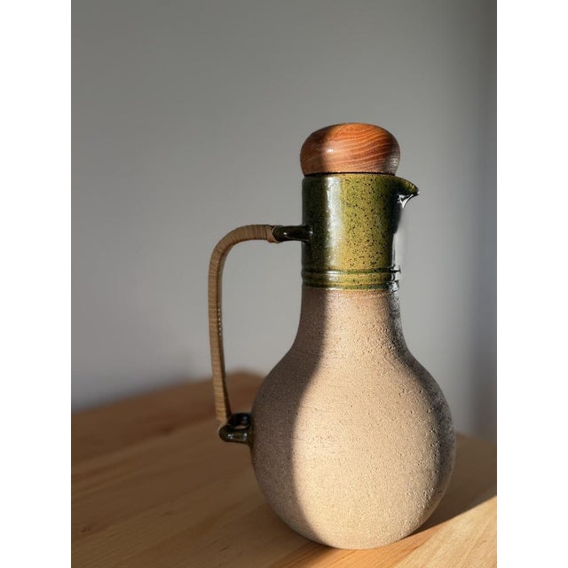 Rare Swedish studio pitcher with wood and rattan handle, designed by Sture G. Ohlsson This piece has an attribution mark,...