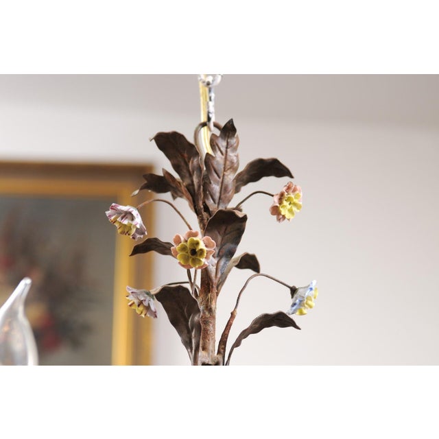 A French Baroque style three-light chandelier from the 20th century with pink and blue flowers, rewired for the USA. This...