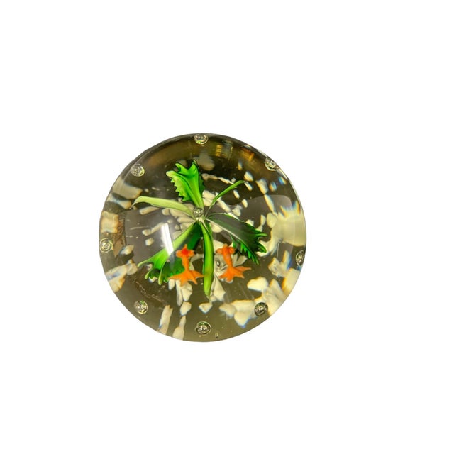 Vintage handblown glass paperweight with glass goldfish inside .