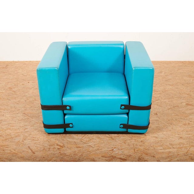 Armchair "Gufram" Base of wood lacquered black, armchair of foam covered with vinyl, cushion held by plastic straps....