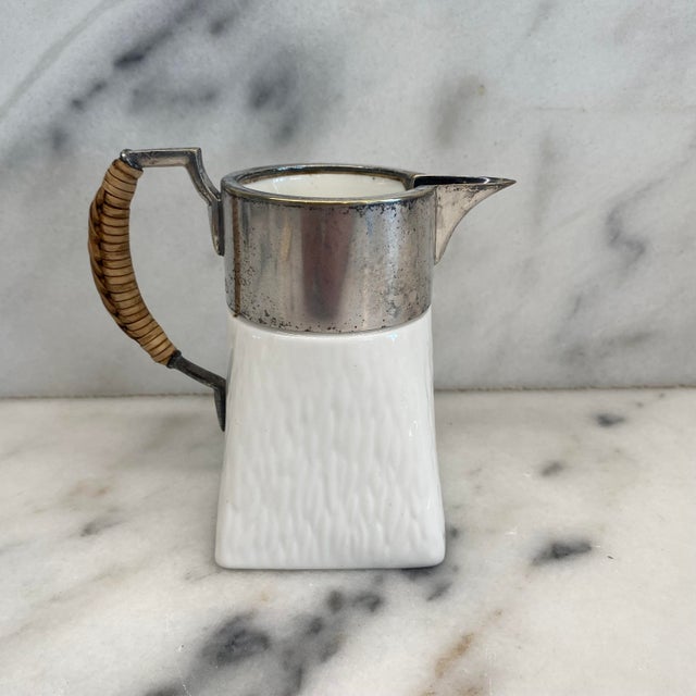 Elegant mid-century Wedgwood cream pitcher, crafted in England in finely textured white porcelain and fitted with a...