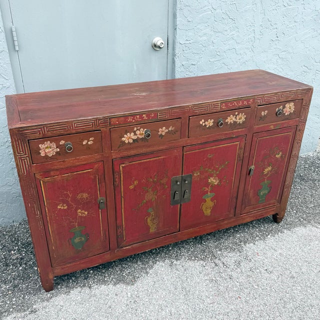 This Chinese red wedding cabinet brings expressive color and intricate decorative detail to a classic credenza silhouette....