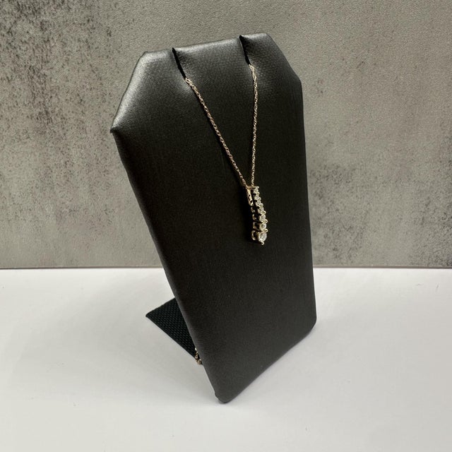 This elegant diamond journey necklace in 10kt yellow gold features 0.25 carats total weight of natural GH SI2–I1 round...