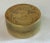 Round brass trinket box with an asian etched design.