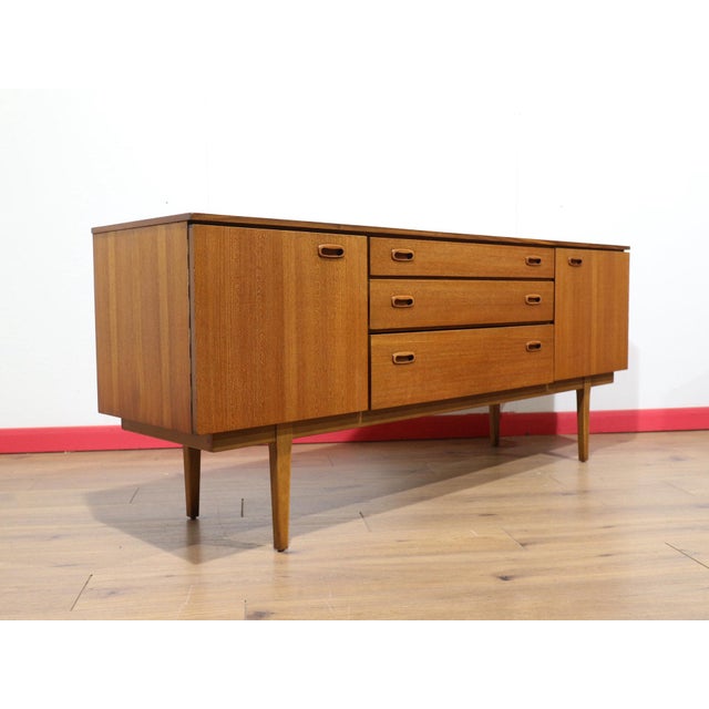 This gorgeous sideboard was designed and manufactured by Nathan Furniture in the mid 1960s, showcasing authentic Danish...