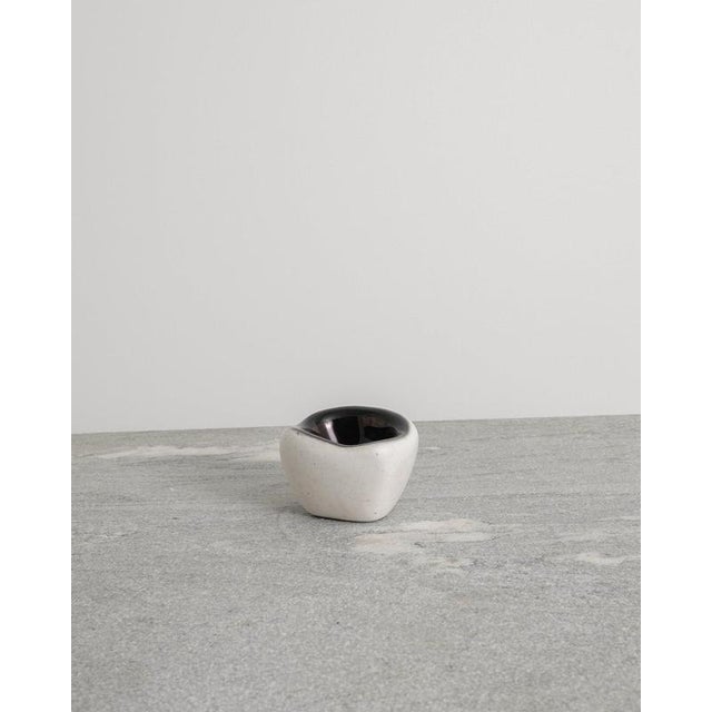 A rare and unique french decorative mid century ceramic bowl in white glaze with an iconic dark golden inside by denise...