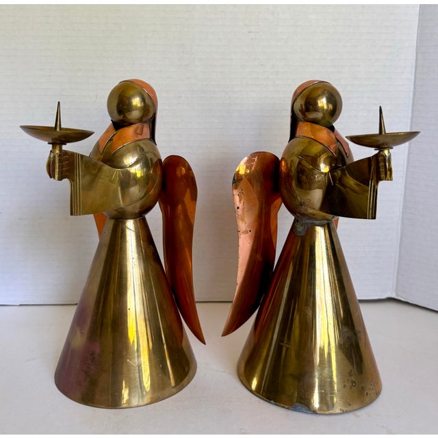 Here is a pair of vintage mid-century brass and copper angel candleholders, made in Hong Kong. Each sculptural figure is...