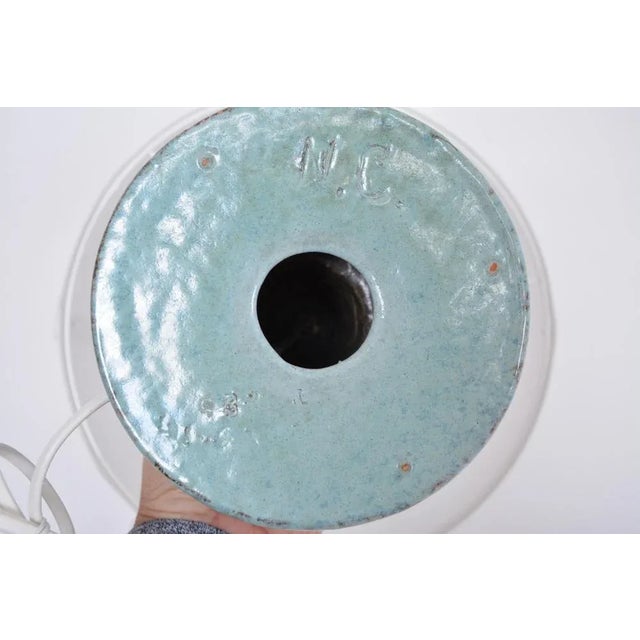 This tall table lamp was manufactured in Denmark probably in the 1960s. The lamp's base is made of stoneware and was...