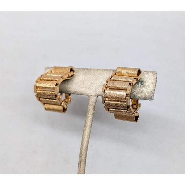 1970s goldtone checked finish rectangular sections with loops at the top and bottom half hoop clip earrings. Marked...