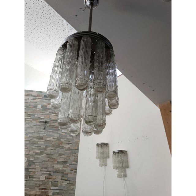 Magnificent and spectacular lighting set by venini. italy, 1970s. the chandelier features a chromed metal frame. suspended...