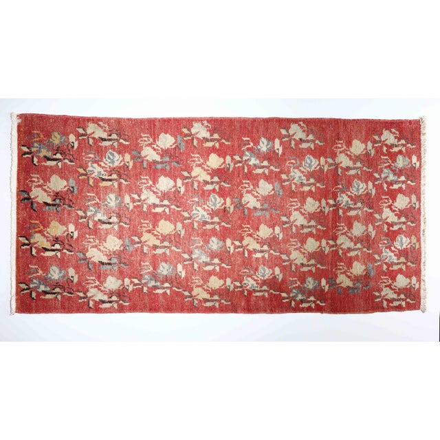 Infuse your space with the vibrant soul of Anatolia. This vintage handwoven rug features a rich crimson field adorned with...