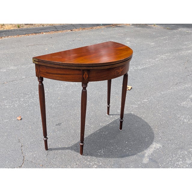 This exceptional late 19th-century Federal style demi-lune flip-top card table seamlessly blends classic American...