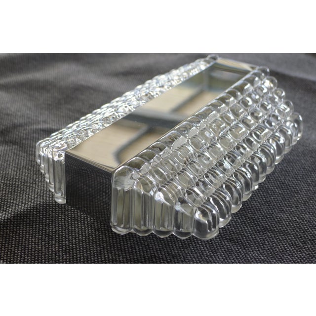 Space Age wall lamp by Kaiser Leuchten from the 1960/70s. Structured ice glass with chrome trim. One E14 lamp socket. This...