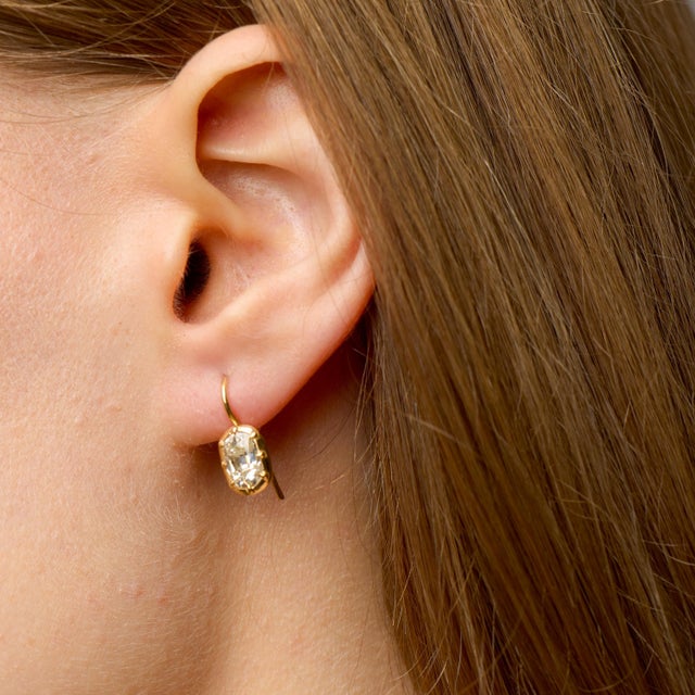 These diamond drop earrings offer a refined interpretation of antique-inspired elegance, centered around the enduring...