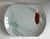 A palette of muted celadon pale sage to blue encompass the pair of Asian-Japanese inspired porcelain bowls. There's a...