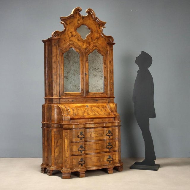Walnut and burl walnut trumeau, crafted in Italy in the early 20th century, exudes timeless elegance with its refined...