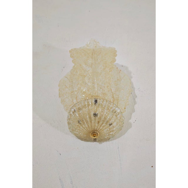 Stunning three-leaf Murano glass wall sconce with a graniglia finish and gold details. This vintage lighting piece dates...