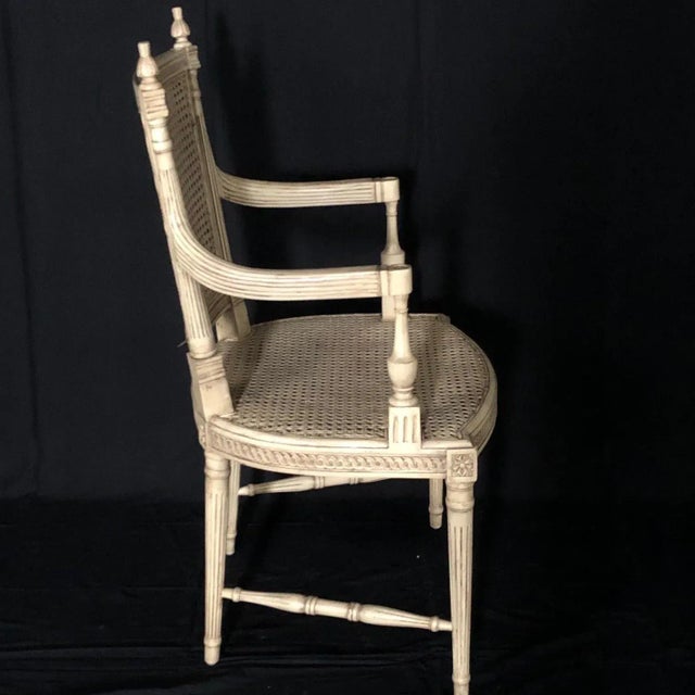 Beautiful ivory painted Louis XVI style armchair having double caning, in great condition! Reeded legs and intricate...