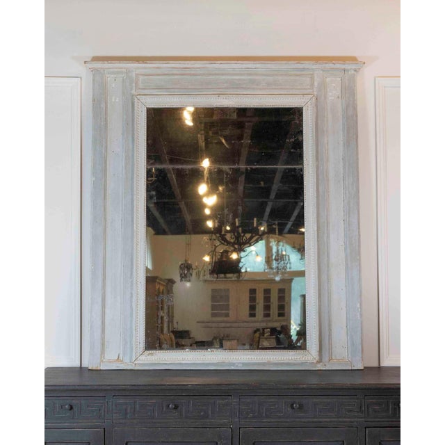 An eighteenth-century French trumeau in the Louis XVI taste, this mirror retains its original plate and original painted...