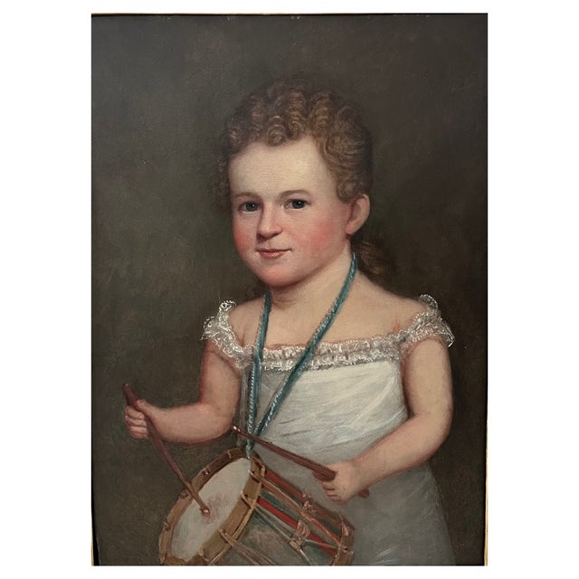 A fine nineteenth century American portrait of a young boy holding a drum. The work is wonderfully rendered with...