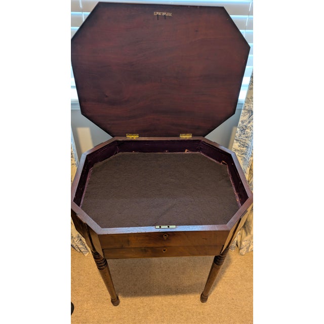 A refined English Regency mahogany sewing stand dating to circa 1810, showcasing the elegant proportions and understated...