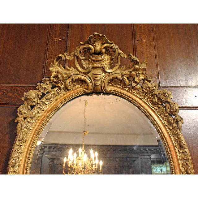 Circa 1860-80 oval carved, giltwood Mirror, French. Grand proportions. Bevelled mirror plate. The splendid Baroque-Rococo...