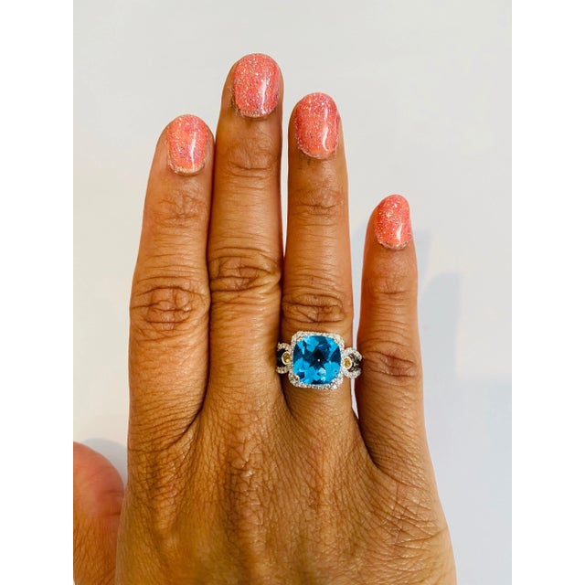 This beautiful Cushion Cut Blue Topaz and Diamond ring has a stunningly vibrant Blue Topaz that weighs 3.97 Carats. It is...