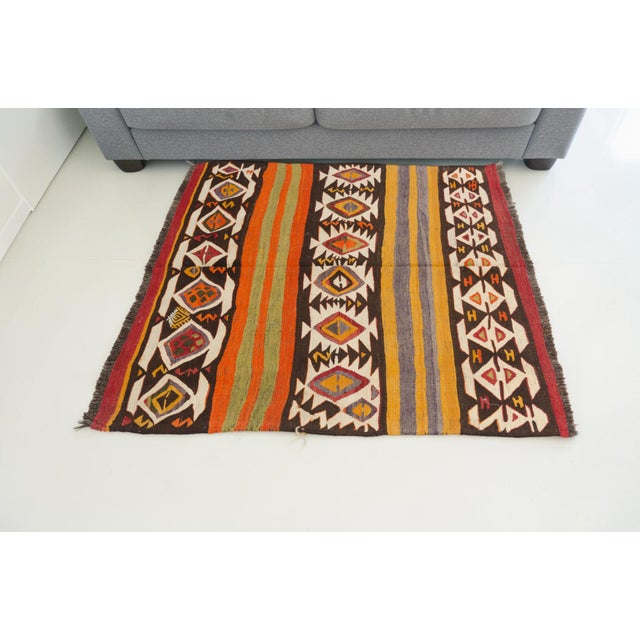 This is a vintage Turkish Oushak rug from the Mid 20th Century. The piece was hand-knotted.