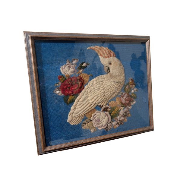 This fine piece of stumpwork boldly displays a white cockatoo surrounded by an arrangement of blooming roses contrasted by...