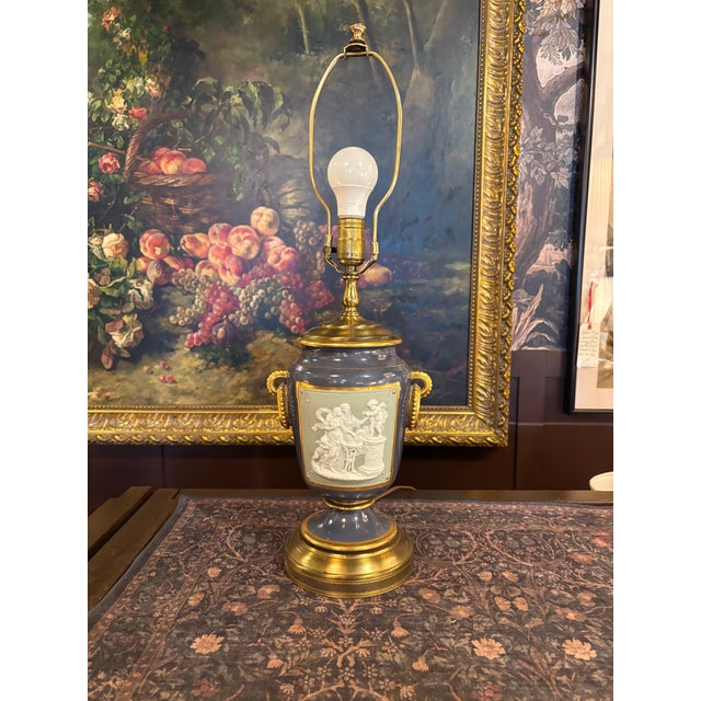 Elegant late 19th-century Victorian pâte-sur-pâte porcelain table lamp featuring a classical figural scene rendered in...