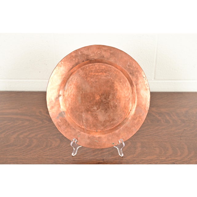 A gorgeous Arts & Crafts period hand hammered copper charger plate or tray In the manner of Roycroft USA, Early 20th...