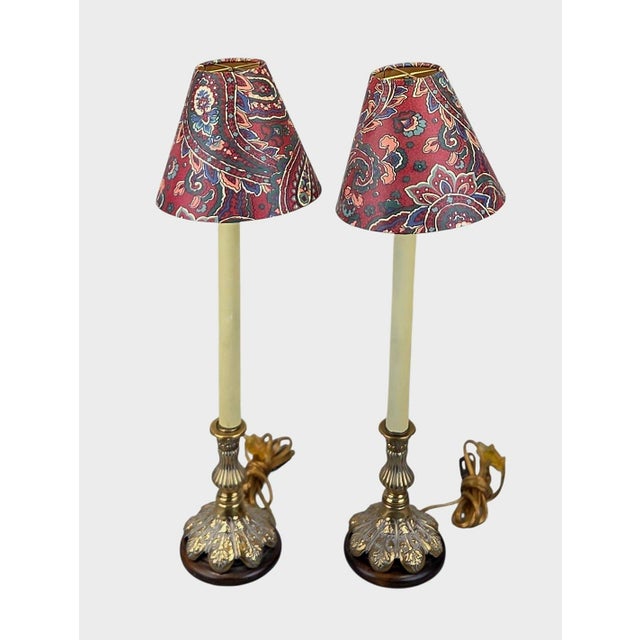 A pair of Frederick Cooper candlestick buffet lamps, Chicago, 1990. Cast brass standards with acanthus leaf brass bases...
