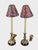 A pair of Frederick Cooper candlestick buffet lamps, Chicago, 1990. Cast brass standards with acanthus leaf brass bases...