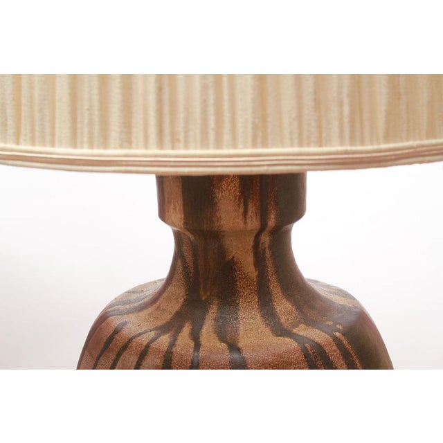 Classic 1960s table lamp with a pleated shade. Ceramic base in various shades of brown. Long cord with switch. Made by...