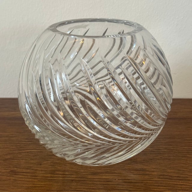 A vintage cut crystal fish bowl or vase featuring a heavy swirl cut design and rounded form. Measures approx: 7W x 7D x...