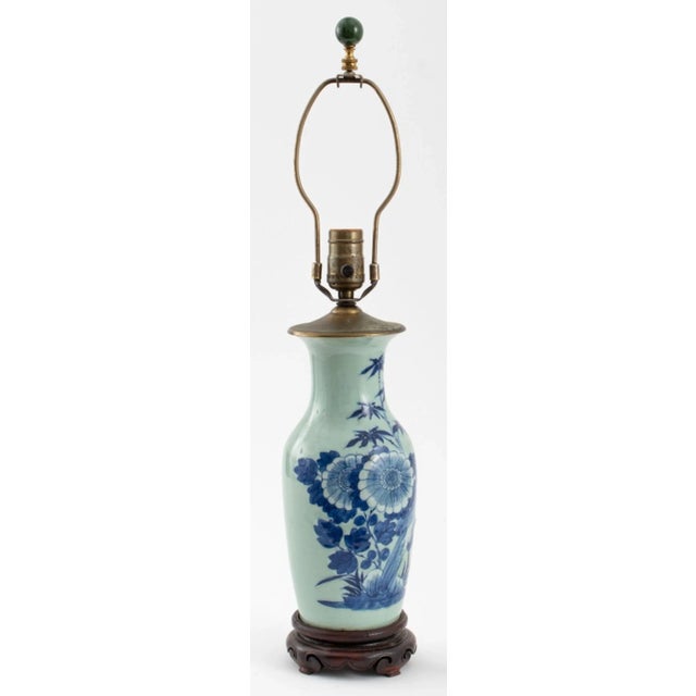 Chinese Blue and White Porcelain Vase Mounted as a Lamp, with floral motif, mounted on carved wood base, 23.75" H x 5.5"...