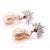 Vivid rubies, chosen for their stunning colour, form a striking focal point that anchors the composition. Their warmth...
