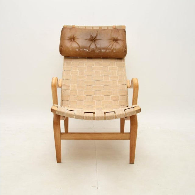 An iconic and extremely comfortable vintage Swedish Pernilla armchair by Bruno Mathsson for Dux. This was made in Sweden,...