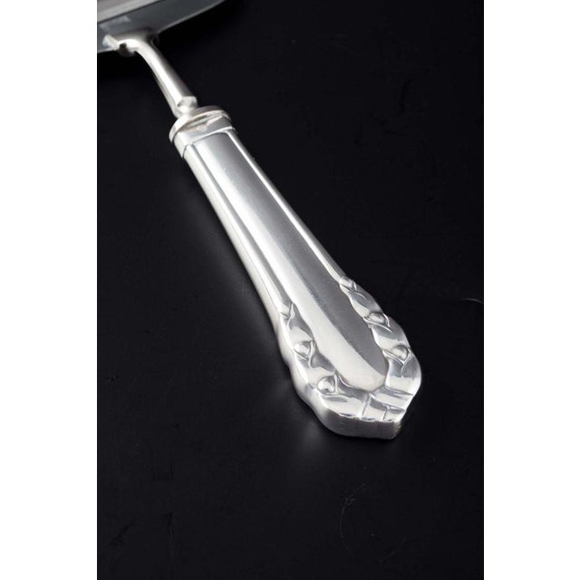 Georg Jensen, Denmark. Cheese slicer in the “Lily of the Valley” pattern. Mirror-polished sterling silver, with an elegant...