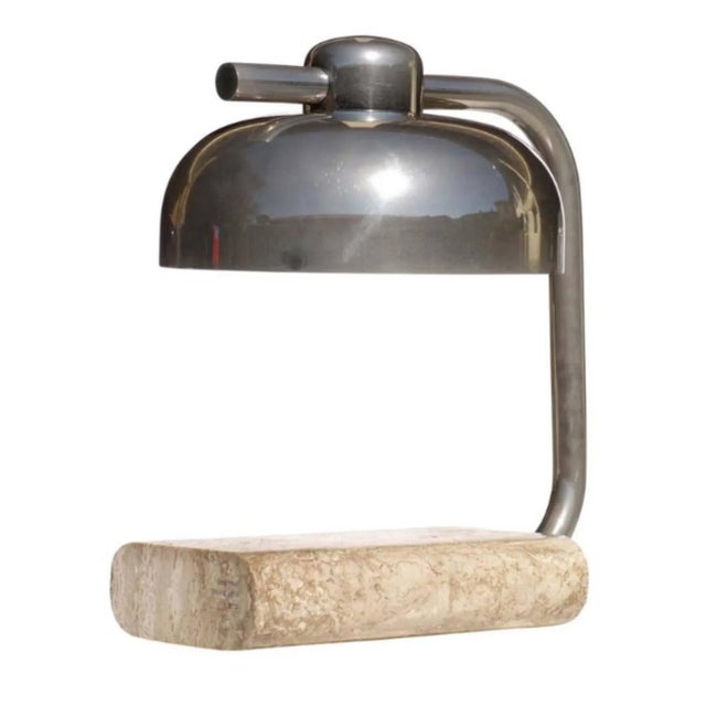 This vintage table lamp by Paolo Salvi features a Travertine marble base and a steel frame. This piece has an attribution...