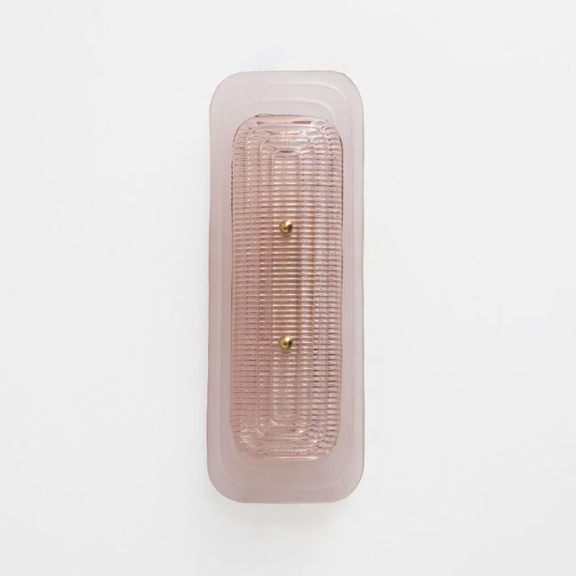 Elegant Italian wall sconce crafted from Murano glass, distinguished by its elongated silhouette and softly rounded...