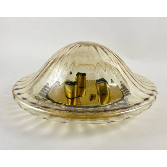 Vintage flush mount chandelier with 3 light points. Corrugated glass shade. This chic ceiling lamp has a gilt brass...