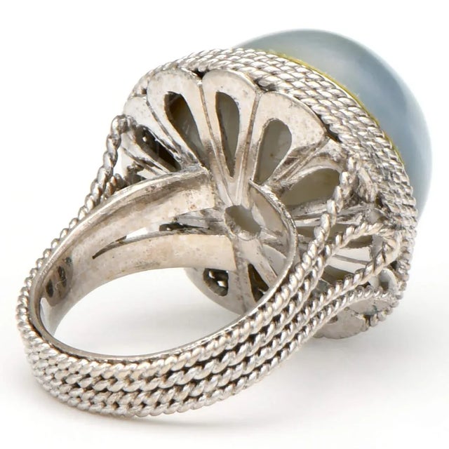 Celebrate your luxurious tastes with this 14KW Bold Gray Mabe Pearl Ring, featuring an exquisite pearl nestled in a bed of...
